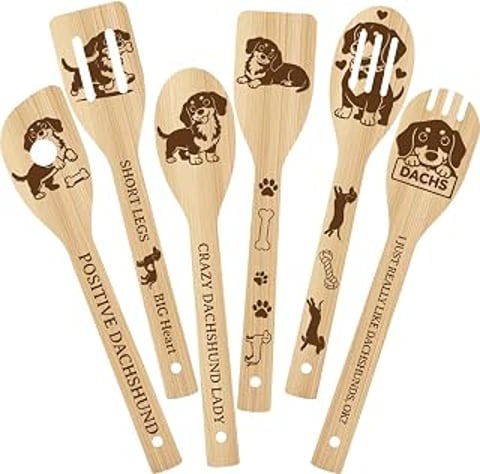 A set of six wooden utensils with dog images on them.