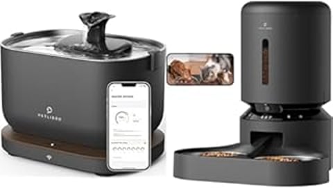 A black and silver blender with a cell phone on top of it.