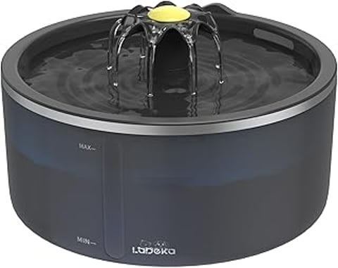 A black cat water fountain with a yellow light.