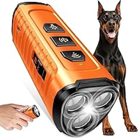 A dog is standing next to a device that is designed to stop barking.