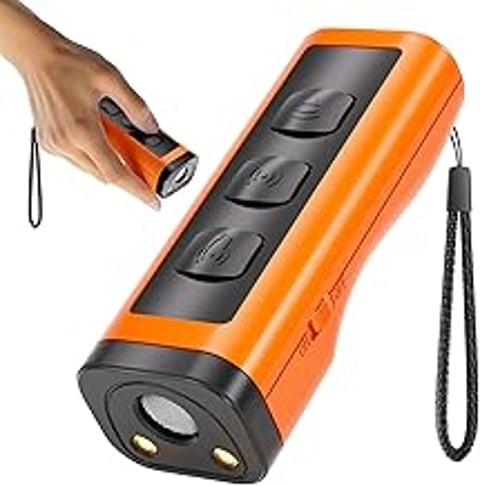 A hand holding a device that is orange and black.