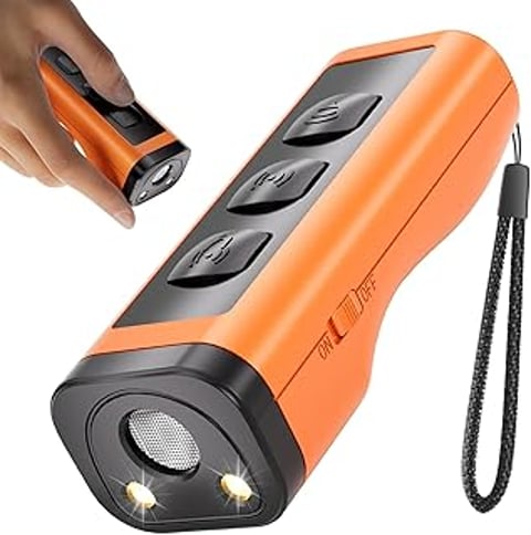 A hand holding a device that is orange and black.