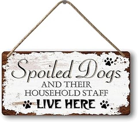A wooden sign that says "spoiled dogs and their household staff live here".