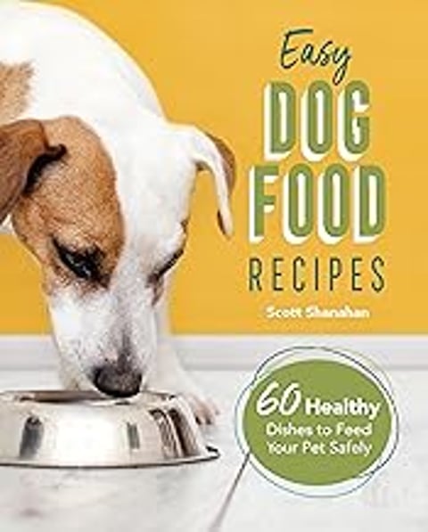 A dog eating out of a bowl.