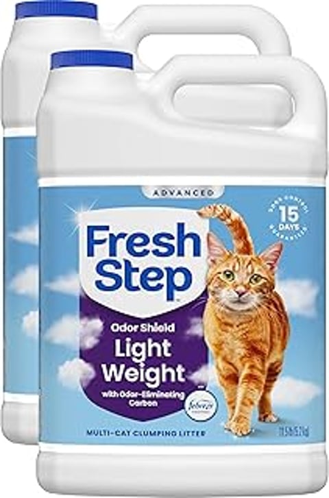 A cat is shown on the packaging of Fresh Step Light Weight Clumping Litter.