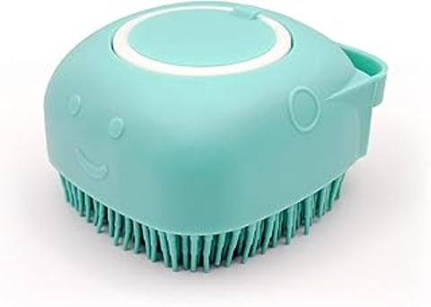A blue dog brush with a built in shampoo dispenser.