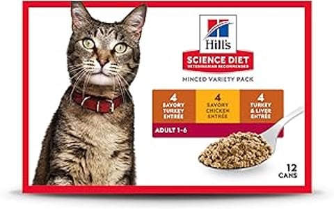 A cat with a red collar is sitting in front of a bowl of Hill's Science Diet Adult 1-6.