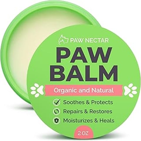 A green and white tube of Paw Balm.