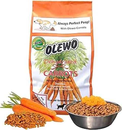 A bag of carrots for dogs sits next to a bowl of food.