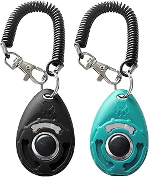 Two dog training clickers with wrist straps.