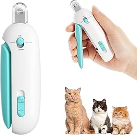 A cat nail clipper with a cat sitting on top of it.