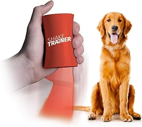 A red ShakeTrainer is held by a person next to a dog.