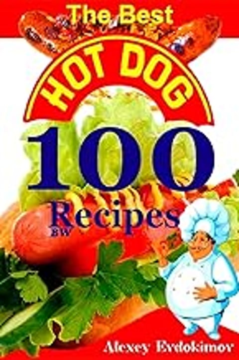A man wearing a chef's hat is holding a hot dog.