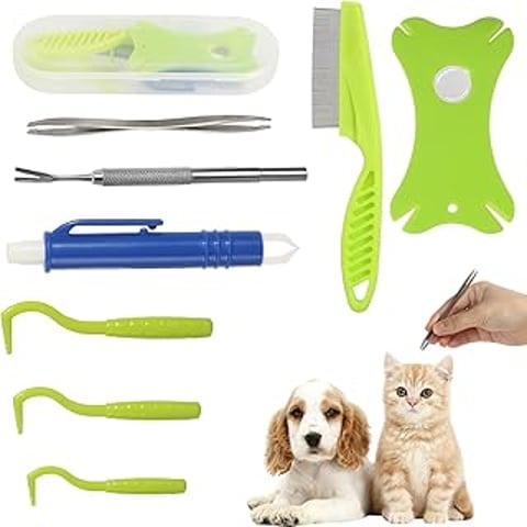 A cat and a dog sitting next to a tick removal tool.