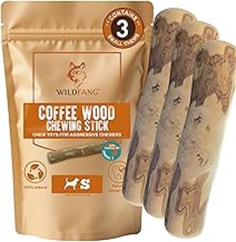 A bag of Wildfang Coffee Wood Chew with a dog chewing on it.